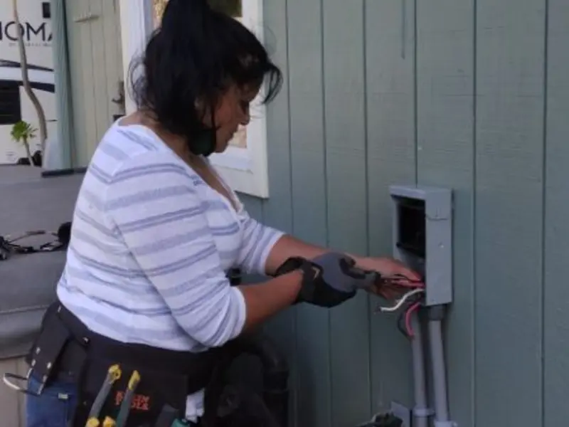 Licensed electrician wiring an exterior subpanel in San Mateo